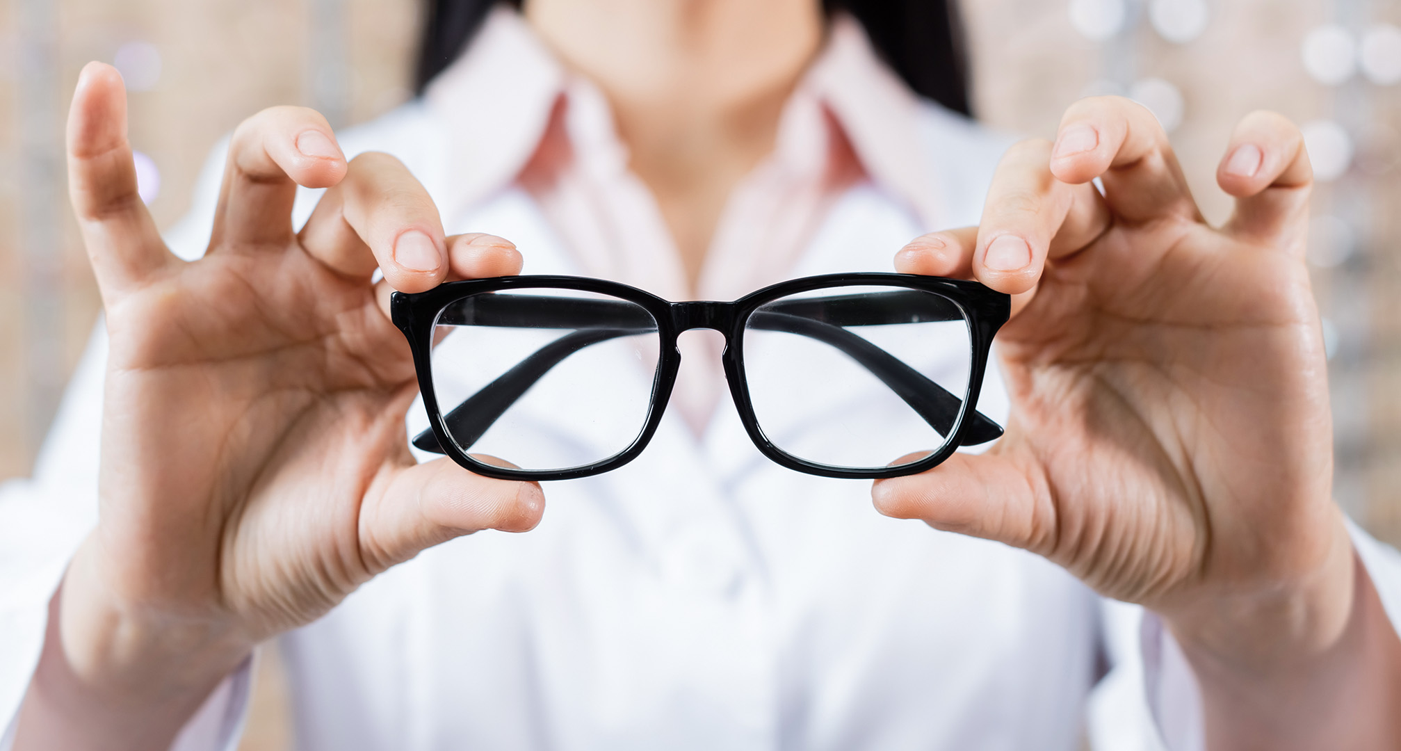 holding black glasses